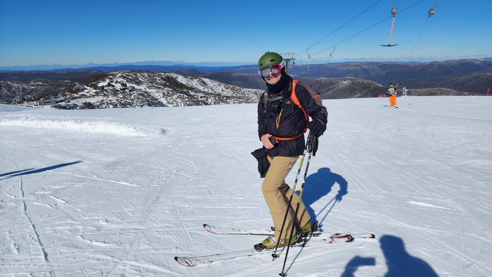 A skier at Falls Creek with the Alps behind
