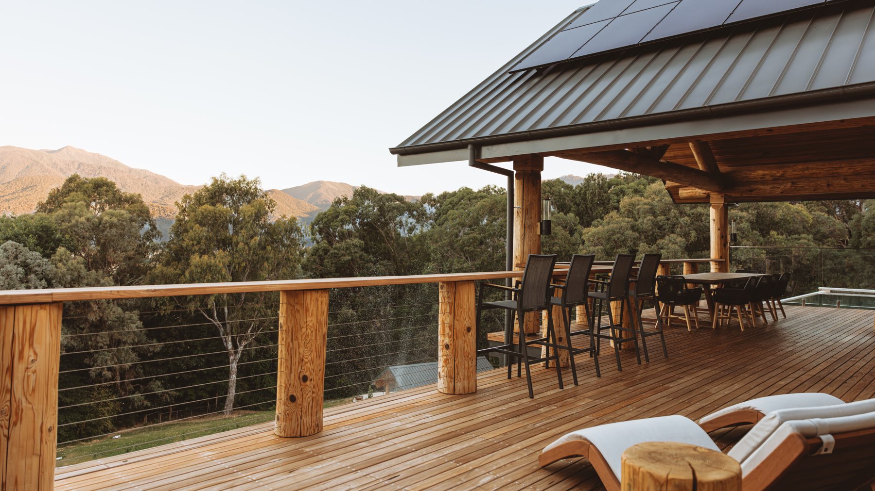 The long table under the timber shelter on the Log Banya deck