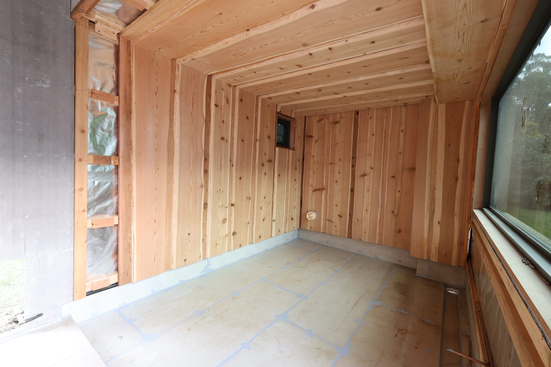 Cedar lining and a small window in the Bright banya