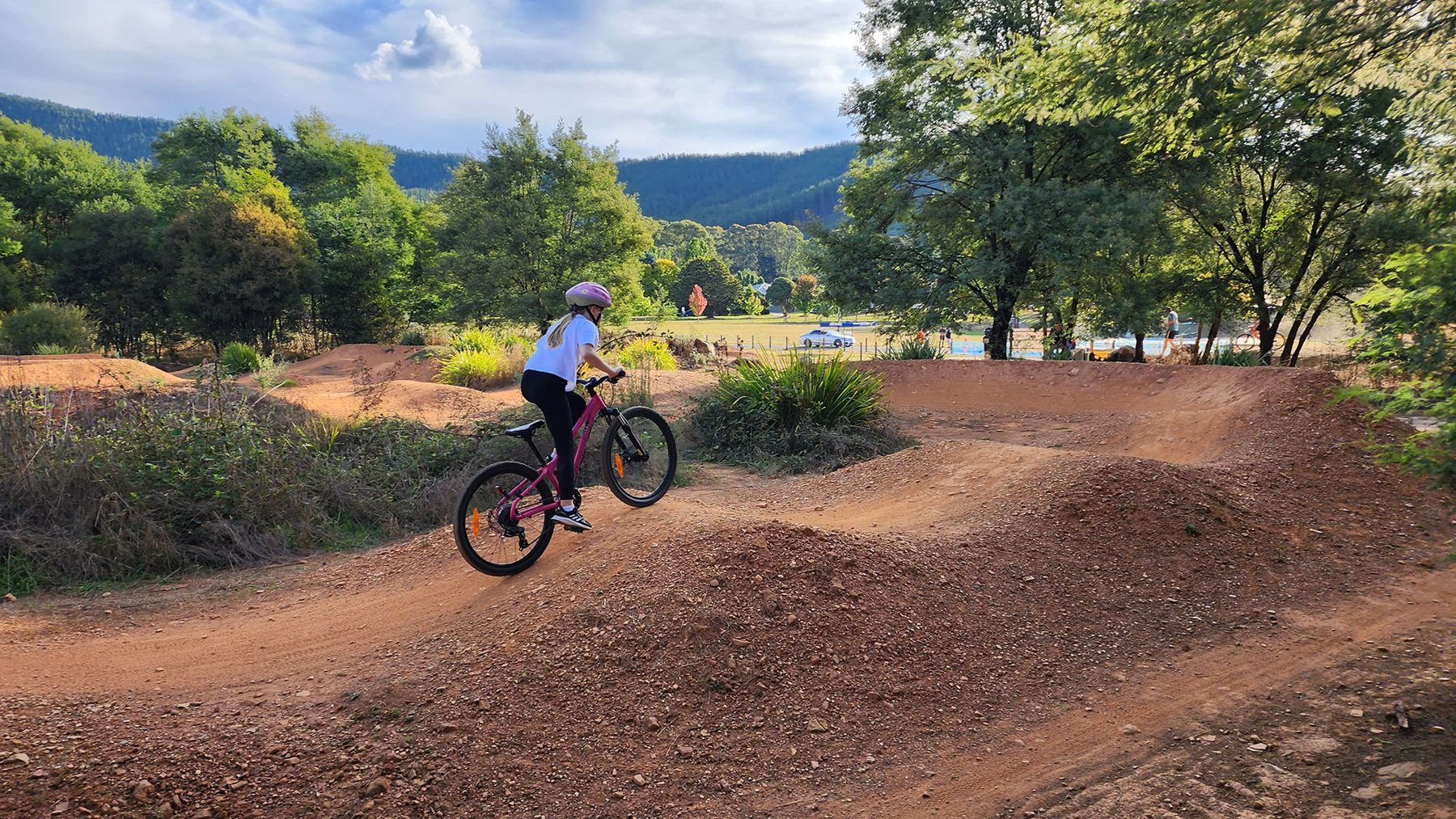 Mountain biking on a dirt pump track