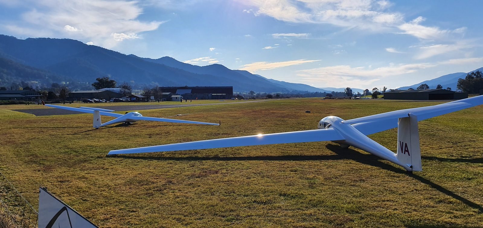 A glider on the Mount Beauty airfield with the mountains behind