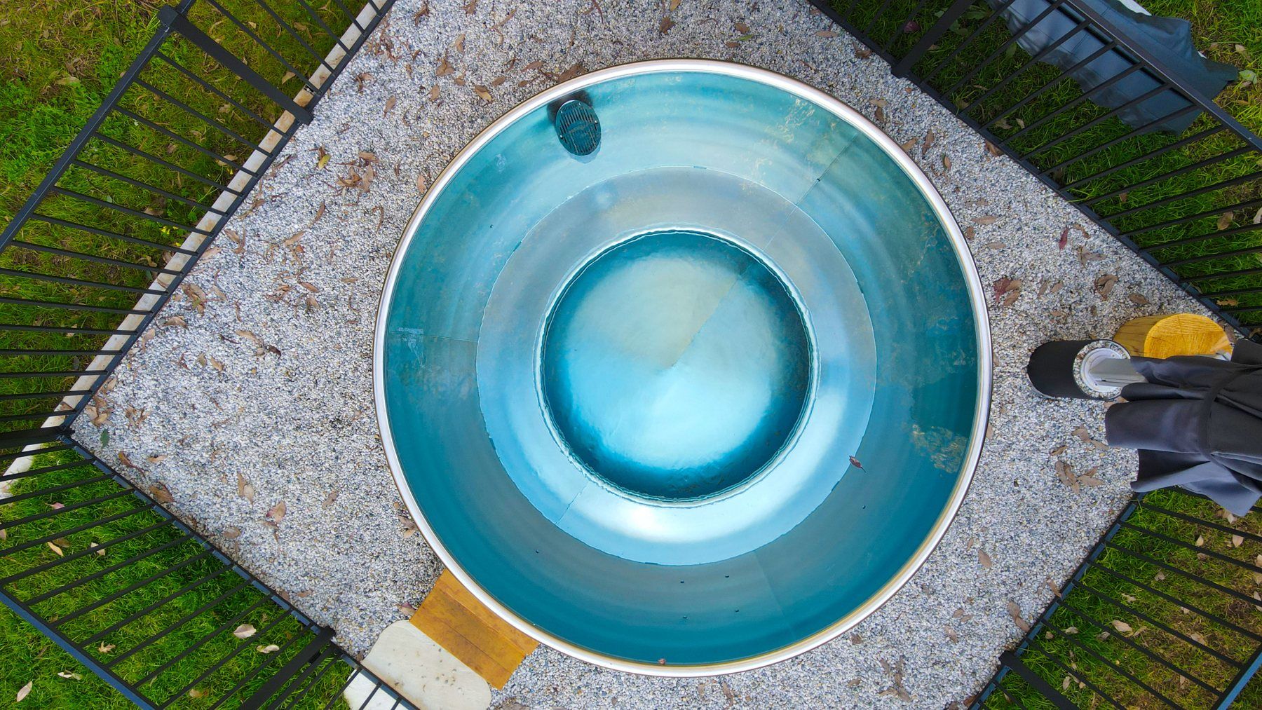 The hot spa at Bogong Nights yurt glamping from above, turquoise water on the stone terrace