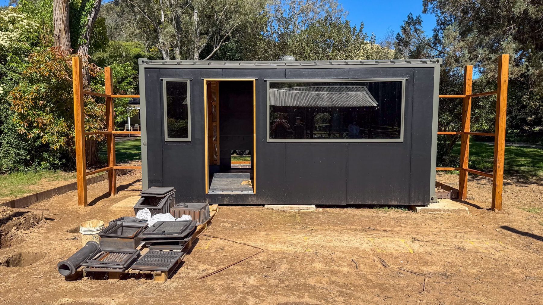 The Bright banya taking shape: the container in place, the posts up and the deck framing going in