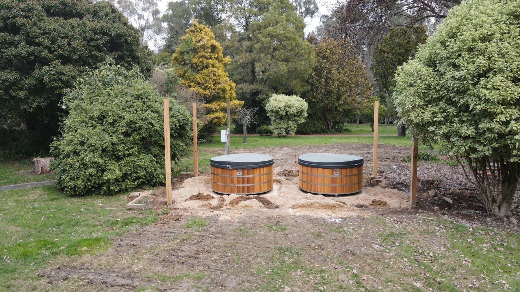 The two Stoked Stainless spas being installed in the garden