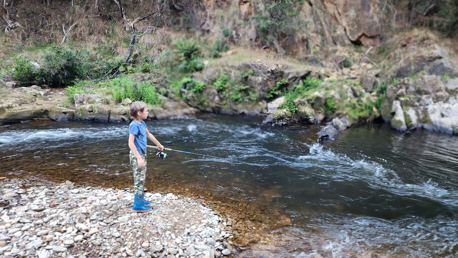 A child fishing in the Ovens River