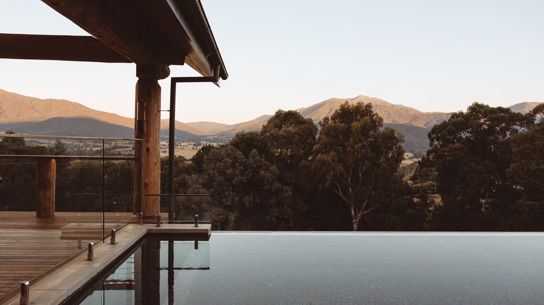 The Log Banya infinity pool at dusk, Mount Beauty — private sauna sessions with a view