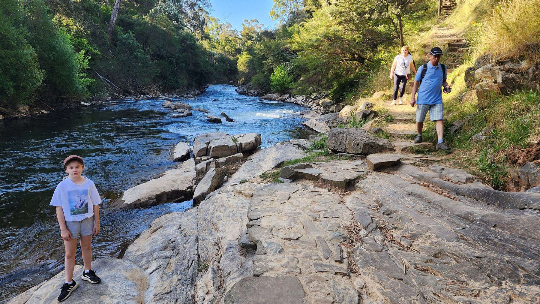 Walkers on the Murray to Mountains Rail Trail beside the river near Bright