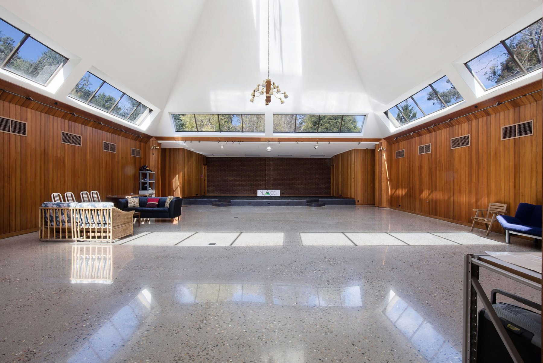 Inside the Pyramid at The Banya Place, Bright: the communal lounge under the glass apex, timber walls and sofas